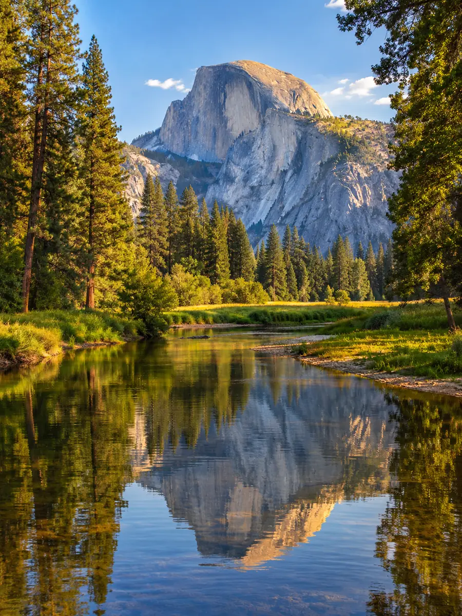 Half Dome reflected in a calm bend of the Merced River in Yosemite Valley
